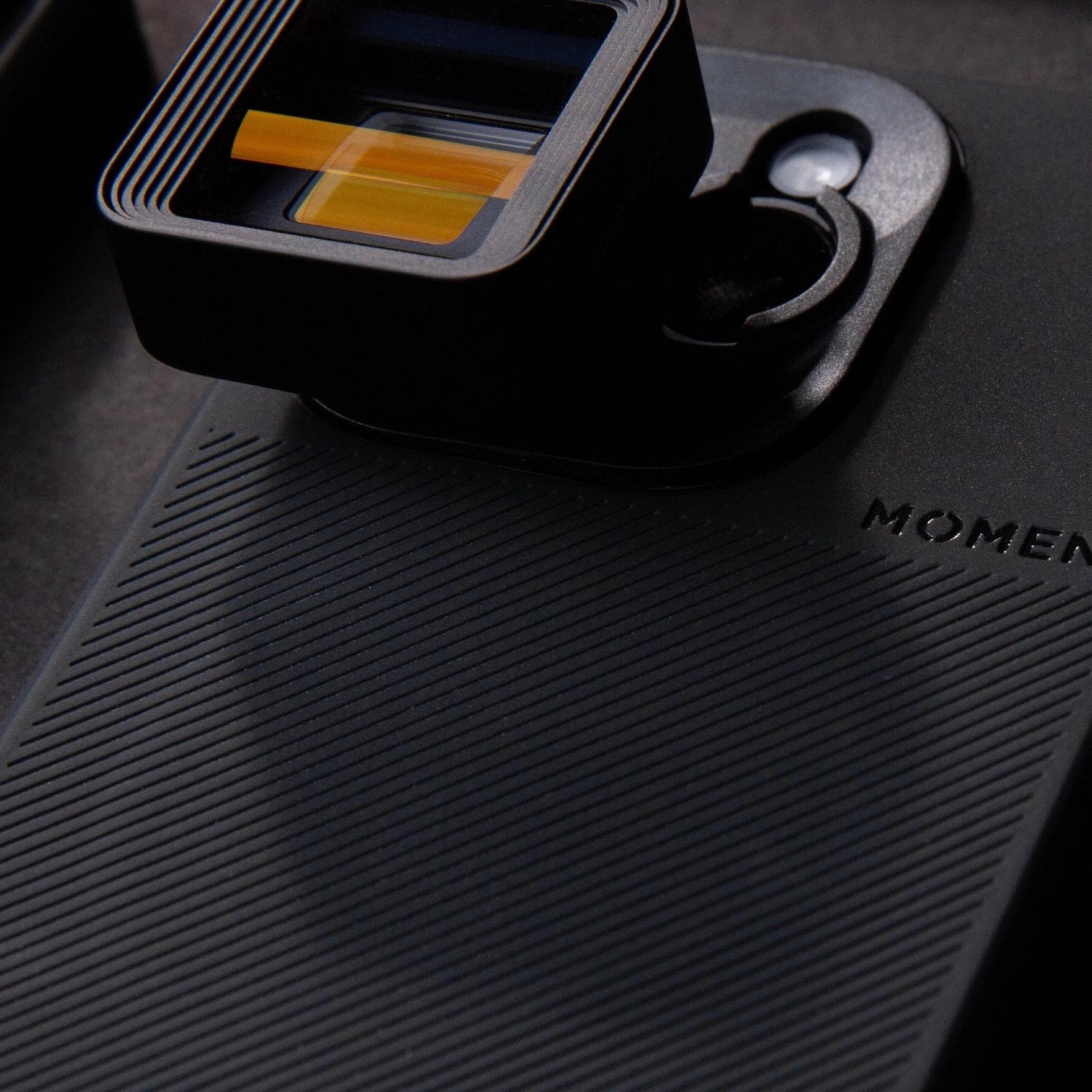 T-Series anamorphic lens on a black iPhone 15.