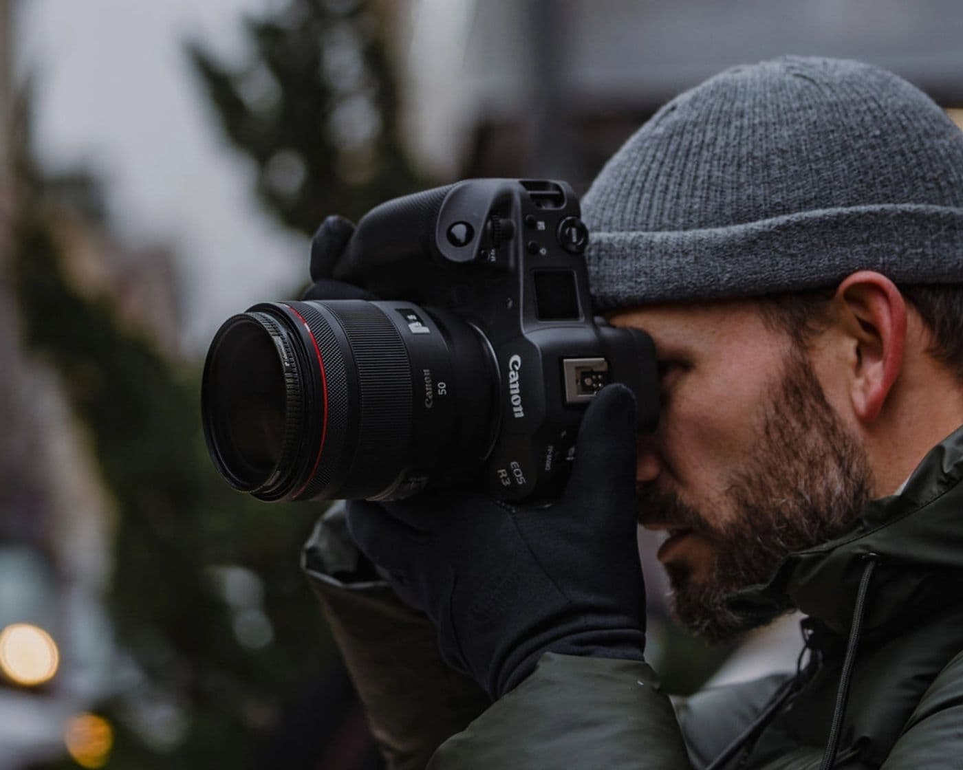 Man shooting with the ShortStache filter attached to his Canon R-series camera in the streets.