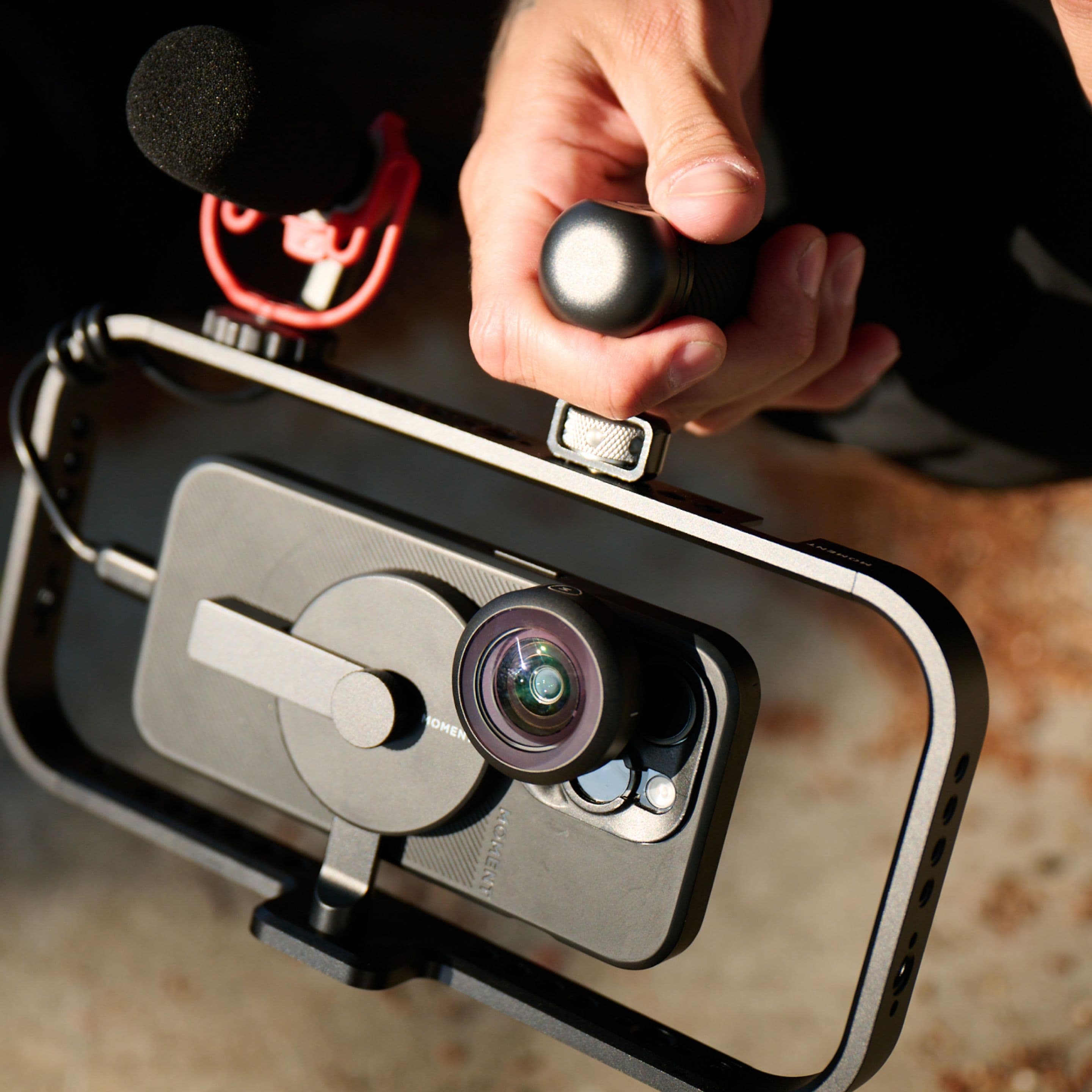 iPhone 16 with attachable mobile lenses on the filmmaker cage.