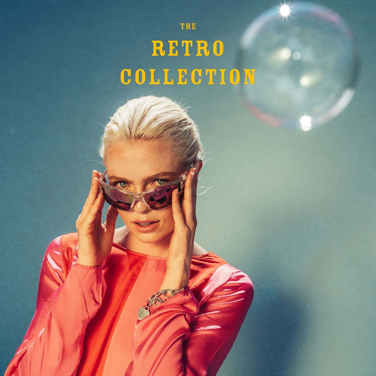 a woman wearing sunglasses and a pink jacket is on the cover of the retro collection .