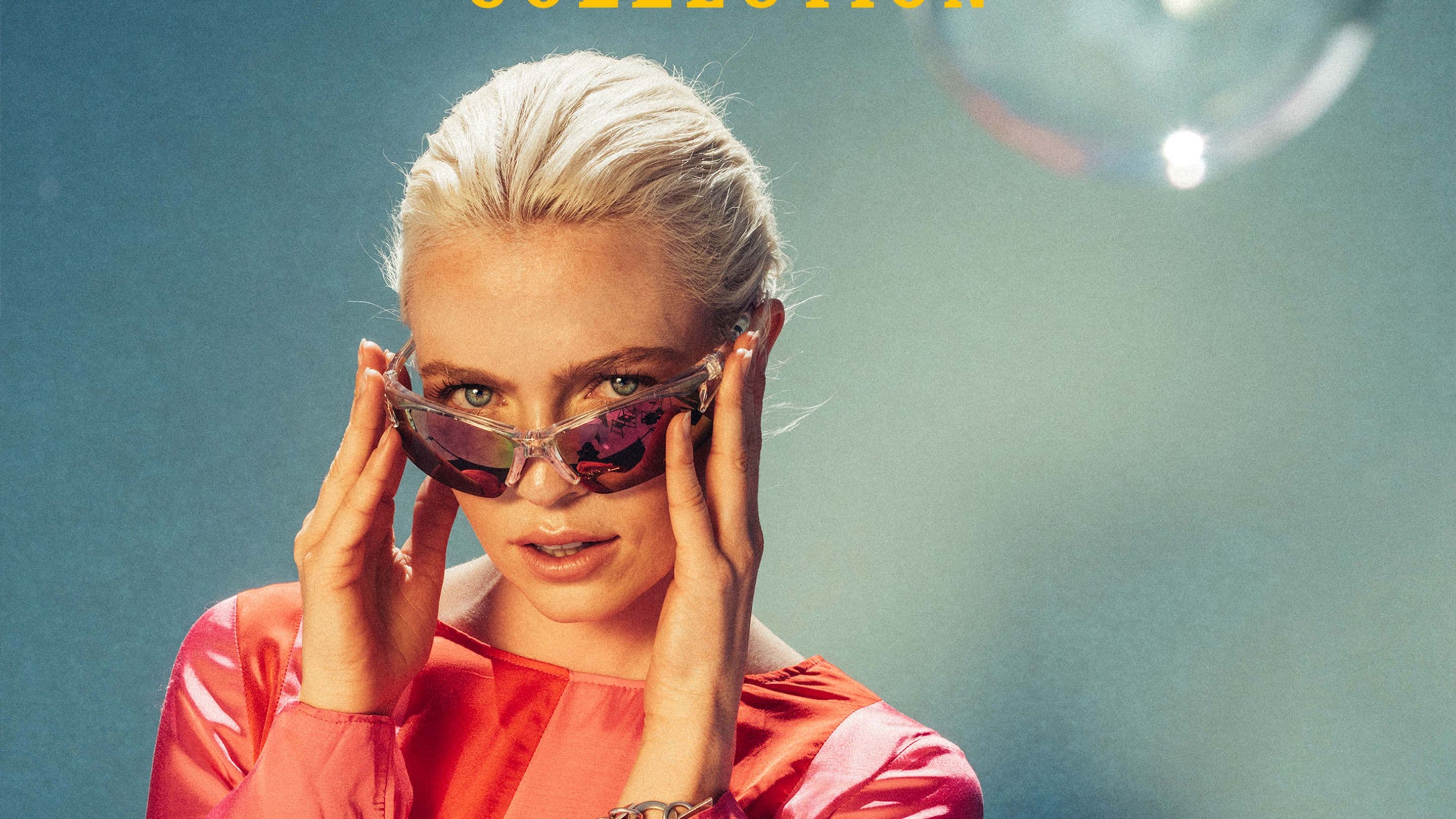 a woman wearing sunglasses and a pink jacket is on the cover of the retro collection .