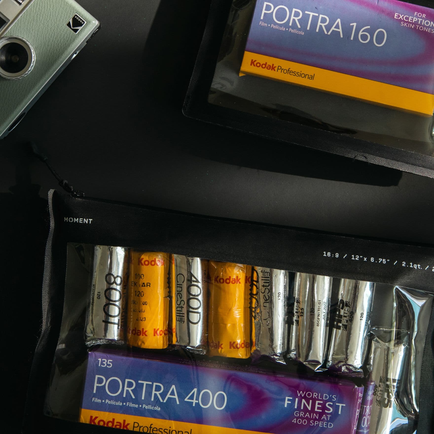 Kodak film rolls packed inside a film pouch with the Kodak Ektar H35 camera on the table.